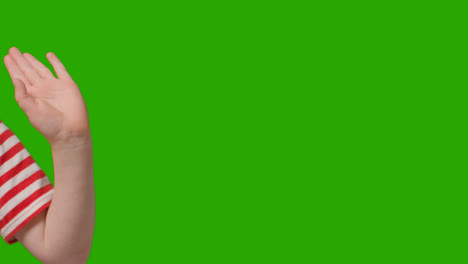 Close-Up-Of-Young-Boy-Waving-To-Camera-Against-Green-Screen